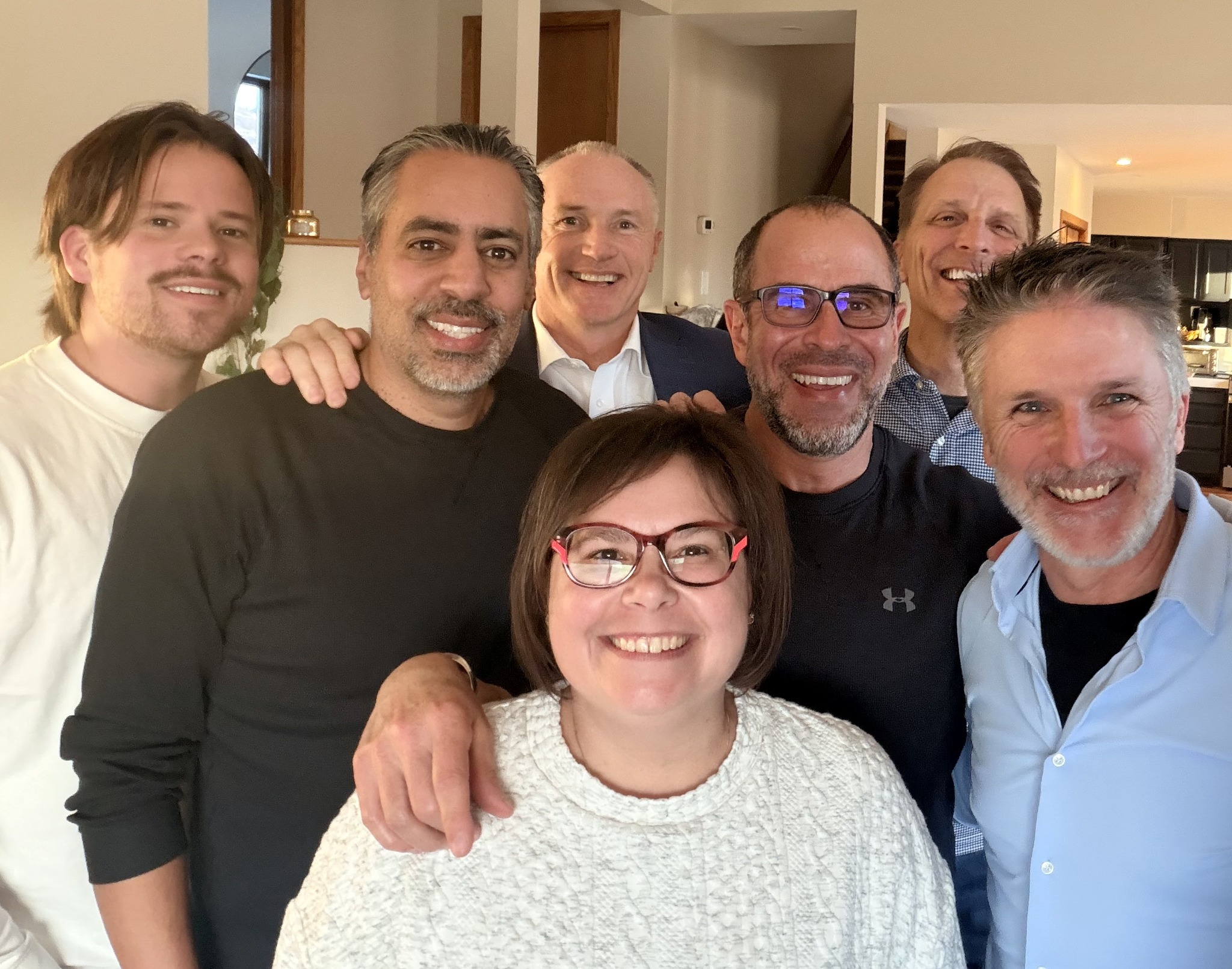 Tomas smiling with a group at an informal gathering